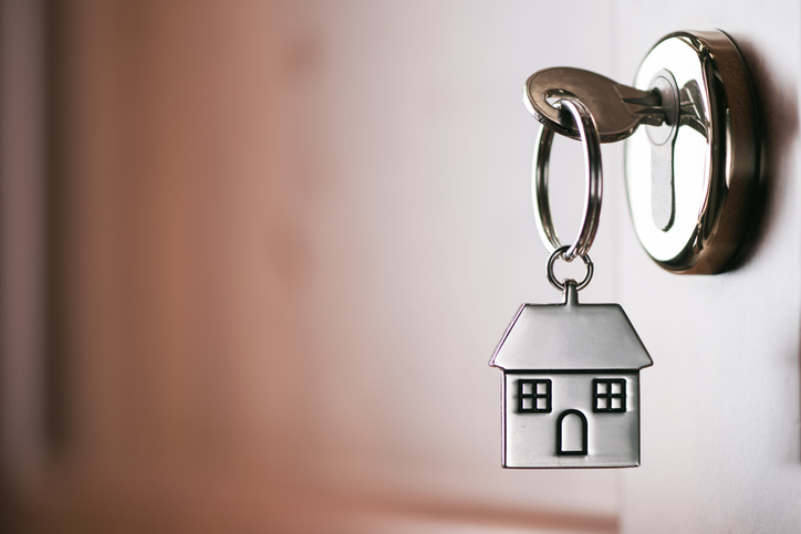 A house key turning in a front-door lock